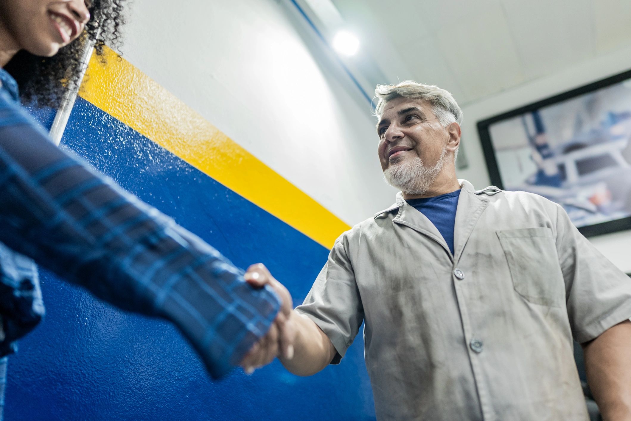 mechanic shaking hands with customer